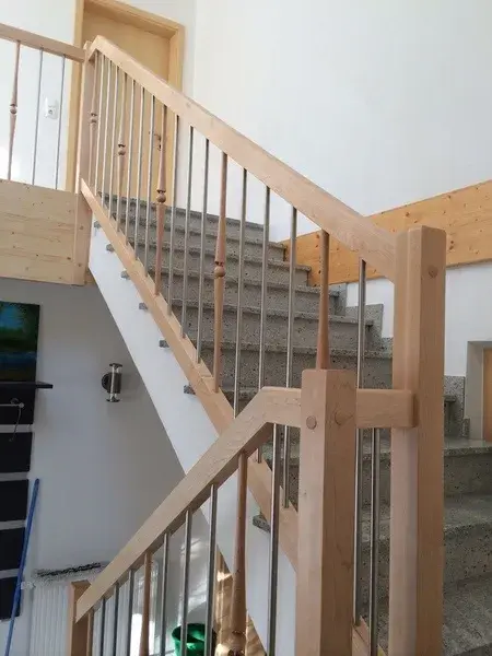 Treppen mit Steinstufen und Geländer in hellem Holz